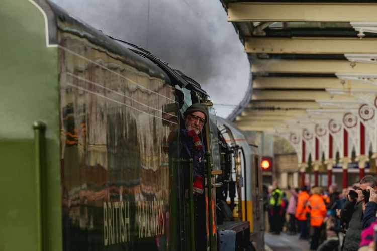 The Tornado steam engine comes into the station, pushed by diesel rolling stock, at Skipton station, West Yorks. The nine year old, scale replica locomotive doesn't have enough fuel to make the return journey, so only travels under full steam power when going north. February 14, 2017.