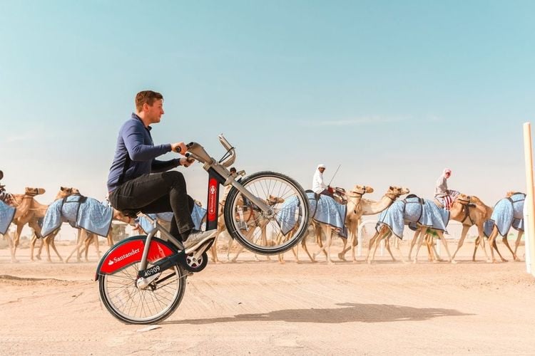 Chris Astil-Smith, 24 (L) with his The Boris bike in Dubai. See National copy NNBIKE: A biking mad entrepreneur made a round the world cycling trip - on a Boris bike. Chris Astil-Smith, 24, rented the Boris bike and cycled around seven cities including New Delhi, Las Vegas and Paris. For three weeks in January Chris cycled around five countries and spent two days in each city capturing the trip with friend and videographer Alex Tyrwhitt. He faced security trouble in New York as well as Delhi where the entrepreneur was forced to bribe security £10 at the Taj Mahal to cycle inside.