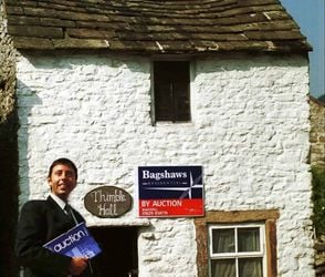 Mark Bramell from estate agents Bagshaws.  Derbyshire is home to a property once listed as the smallest detached house in Britain - Thimble Hall in Youlgreave.  See NTI story NTITHIMBLE.  It dates back to 1756 and measures just 11ft 10in x 10 ft 3in and stands 12 ft 2in high. Stretch out your arms and you practically touch either side of the rooms.  In August 2000, the Guinness Book of Records proclaimed it the smallest detached property in Great Britain. And yet 100 years ago, a family of eight lived there.  Such is its quirkiness, when it went up for auction in 1999 it sparked bids from all over the world including Hong Kong, Athens and New York. It's claimed there was even an offer from Uri Geller.