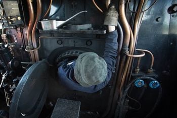 Nick Battle climbs in to the firebox on the Flying Scotsman. See SWNS story SWTRAIN; Flying Scotsman at St Philips Marsh depot, Bristol. Flying Scotsman was originally built in Doncaster for the London and North Eastern Railway (LNER), emerging from the works on 24 February 1923 and initially numbered 1472. It was designed by Sir Nigel Gresley as part of the A1 class – the most powerful locomotives used by the railway. Discover more about Scotsman.