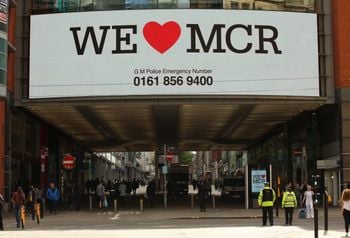 We Love Manchester signs have begun to pop up around the city to show solidarity and to share a helpline for those effected by last nights terror attack in the city. At least 22 people have died, with more than 60 injured after an 'explosion' tore through a pop concert at Manchester Arena in a suspected terror attack. In a statement, GMP said: "This is currently being treated as a terrorist incident until police know otherwise." Officers were called to reports of an explosion at the Manchester Arena just before 10.35pm on Monday, May 22. "So far 19 people have been confirmed dead, with around 50 others injured," the force said. Multiple witnesses reported hearing two "huge bangs" at the venue shortly after US singer's gig finished at around 10.30pm on Monday evening. The area around the arena was swamped with police and emergency services and approach roads were cordoned off.