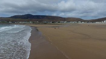 Villagers are delighted after this entire beach that was washed away 33 years ago has re-appeared - virtually overnight thanks to a freak tide. See SWNS story SWBEACH; The stunning beach near the Irish village of Dooagh on Achill Island vanished in Spring storms of 1984 after waves washed away all the sand. With nothing more than rock pools left behind, almost all the villages' hotels, guesthouses and cafes shut down. But miraculously thanks to a freak tide, hundreds of thousands of tons of sand were dumped on the beach over ten days in April, re-creating a stunning 300m long beach.