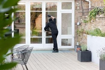 Burglar standing at patio door