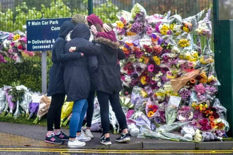 FILE PICTURE - A group of girls console each other in front of a floral tribute in memory of Bailey Gwynne is seen outside the gates to Cults Academy near Aberdeen, Scotland on October 29 2015.See Centre Press story CPBAILEY; This is the face of the killer who stabbed a fellow school pupil to death and can legally be named for the first time after turning 18-years-old. Daniel Stroud was found guilty of stabbing Bailey Gwynne to death in the corridors of a high-achieving secondary school as an argument took a dark turn for the worse. Stroud regularly brought knives with him to Cults Academy in Aberdeen prior to the incident which cost Bailey his life on October 28 of 2015. The fight was said to have started over a biscuit and escalated when someone called Bailey's mum fat.