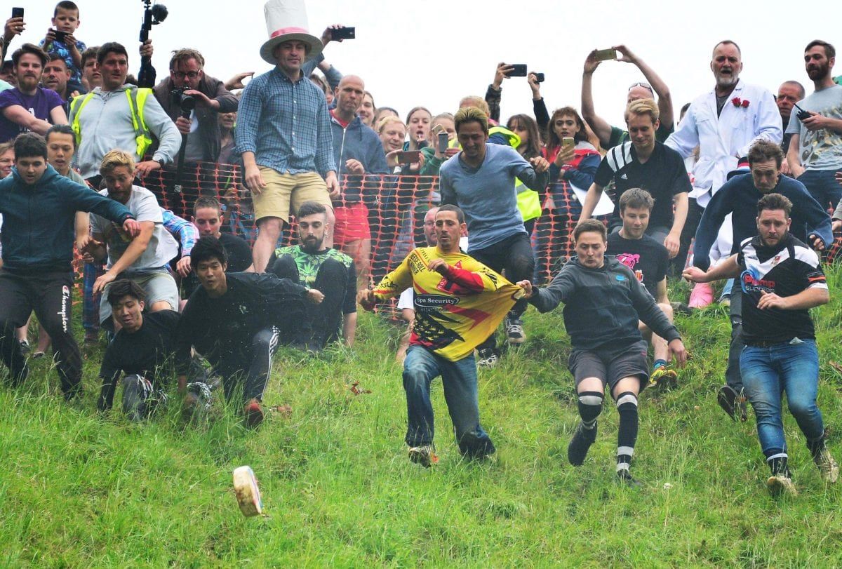 A soldier was named the gratest athlete in the world today after his record-breaking 21st win - at CHEESE-ROLLING. Legendary cheese-chaser Chris Anderson risked life and limb - well mainly limb - hurling himself into the record books for chasing a wheel of Double Gloucester down a super-steep hill.