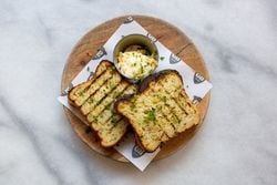 Caravan's Jalapeño cornbread, chipotle butter, coriander, lime Caravan