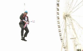 Boris Johnson gets stiuck on a zipwire (PA)