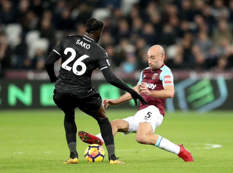 West Ham United's Pablo Zabaleta (right) slides in on Crystal Palace's Bakary Sako (left) during the Premier League match at the London Stadium, London.