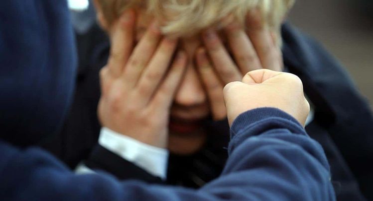 Posed photograph simulating a child being bullied.