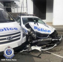 In this Monday, July 22, 2019, photo provided by New South Wales Police, a damaged police vehicle is parked at a police station in Sydney. Police have charged a driver after methylamphetamine valued at more than $140 million was found in a van that crashed into police cars parked outside the Sydney police station. (NSW Police via AP)