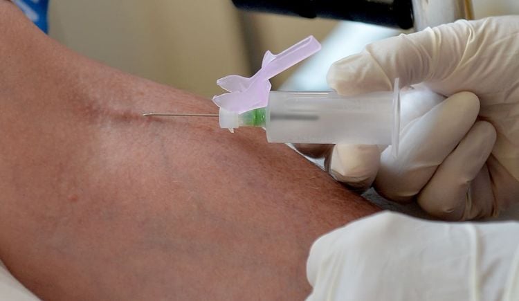 A nurse takes blood at the Temple Fortune Health Centre GP Practice near Golders Green, London.