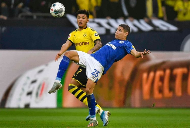 Schalke's Amine Harit, right, and Dortmund's Jadon Sancho challenge for the ball during the German Bundesliga derby soccer match between FC Schalke 04 and Borussia Dortmund in Gelsenkirchen, Germany, Saturday Oct. 26, 2019. (AP Photo/Martin Meissner)