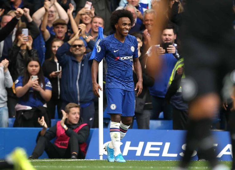 Chelsea's Willian celebrates scoring his side's second goal of the game during the Premier League match at Stamford Bridge, London. Credit;PA