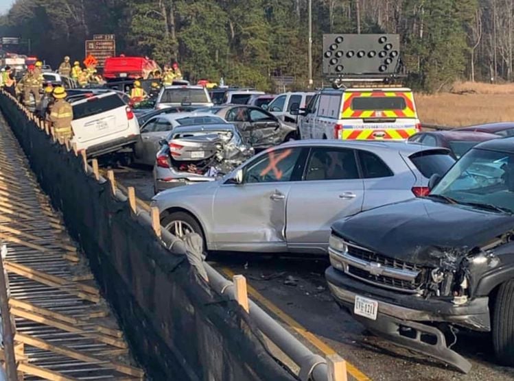 In this photo provided by the Virginia State Police, emergency personnel work the scene of a multi-vehicle pileup on Interstate 64 in York County, Va., on Sunday, Dec. 22, 2019. (Virginia State Police via AP)