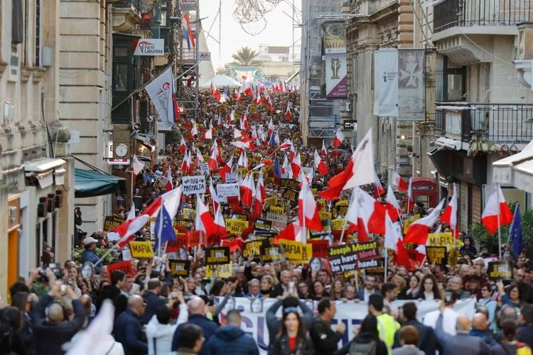 People stage a protest in La Valletta, Malta, Sunday, Dec. 1, 2019. Malta's embattled prime minister has received a pledge of confidence from Labor Party lawmakers amid demands for his resignation by citizens angry over alleged links of his former top aide to the car bomb killing of a Maltese anti-corruption journalist. Hours later, thousands of Maltese protested outside a courthouse demanding that Joseph Muscat step down. (AP Photo)