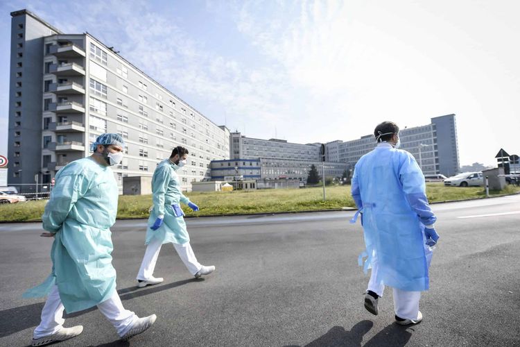 Medical staff walk at the Samaritan’s Purse field hospital that is being set up in Cremona, northern Italy, Friday, March 20, 2020. A Christian evangelical group headed by the son of the late televangelist Billy Graham has sent a field hospital to northern Italy to tend to coronavirus patients, joining China in offering aid to Italy’s overwhelmed health care system. For most people, the new coronavirus causes only mild or moderate symptoms. For some it can cause more severe illness. (Claudio Furlan/LaPresse via AP)