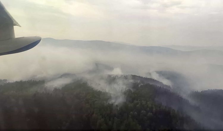 This image taken from video provided by Russian Emergency Ministry, shows a view of a forest fire from a Russian Emergency Ministry multipurpose amphibious aircraft in the Trans-Baikal National Park in Buryatia, southern Siberia, Russia, Thursday, July 9, 2020. About 910 hectares of forest were alight over this area of the Russia's region, according to the ministry of emergency situations. (Russian Emergency Ministry Press Service via AP)