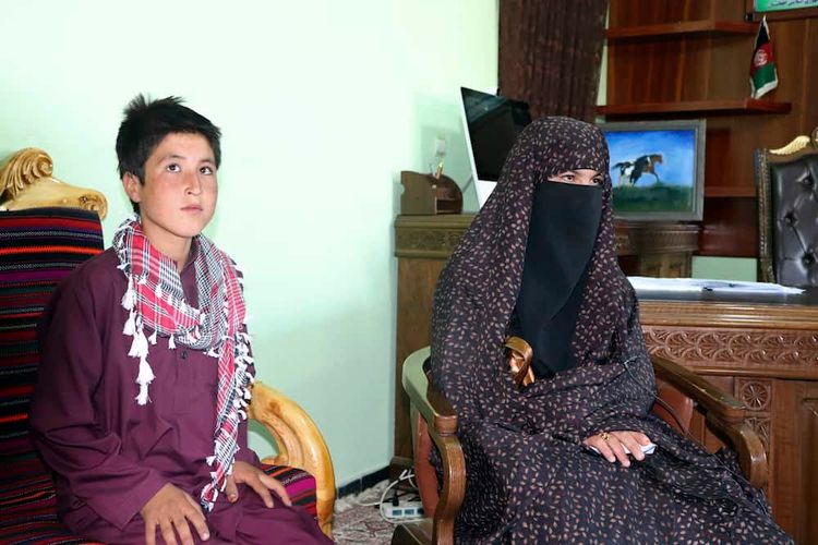 Qamar Gul, 16, right, and her brother Habibullah, 12, left, poses for photograph in the governor house of Ghor province western of Afghanistan, Tuesday, July 21, 2020. A 16-year old Afghan girl who killed Taliban who attacked and killed her parents in western Ghor province has become a local hero. (AP Photo)