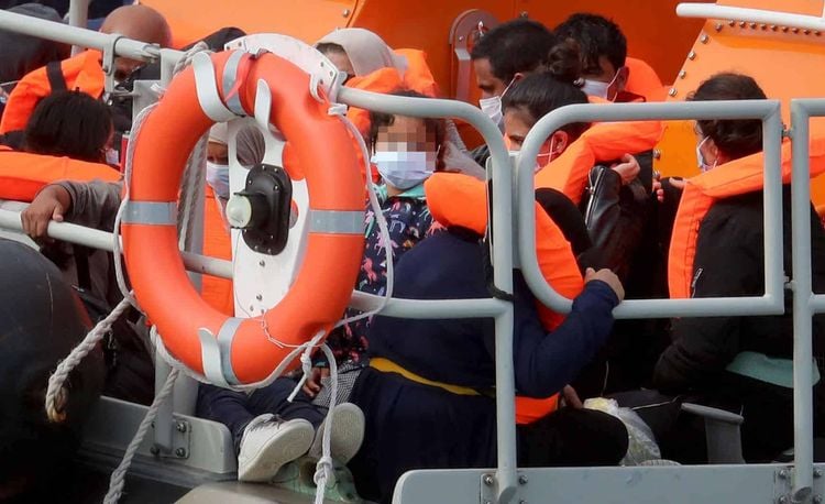 NOTE: FACES HAVE BEEN PIXELATED BY THE PA PICTURE DESK TO PROTECT IDENTITY OF ANY MINORS PRESENT A group of people thought to be migrants are brought into Dover, Kent, onboard the Dover RNLI lifeboat following a number of small boat incidents in the Channel earlier today.