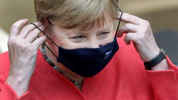 German Chancellor Angela Merkel adjusts her face mask as she arrives for a meeting of the upper house of the German legislative in Berlin, Germany, Friday, July 3, 2020. (AP Photo/Michael Sohn)