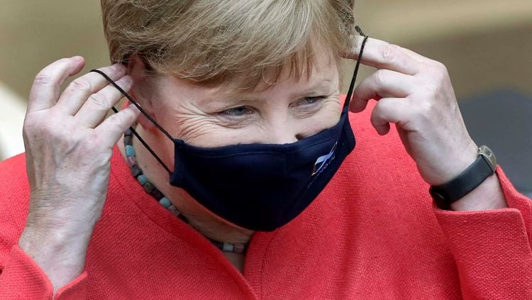 German Chancellor Angela Merkel adjusts her face mask as she arrives for a meeting of the upper house of the German legislative in Berlin, Germany, Friday, July 3, 2020. (AP Photo/Michael Sohn)