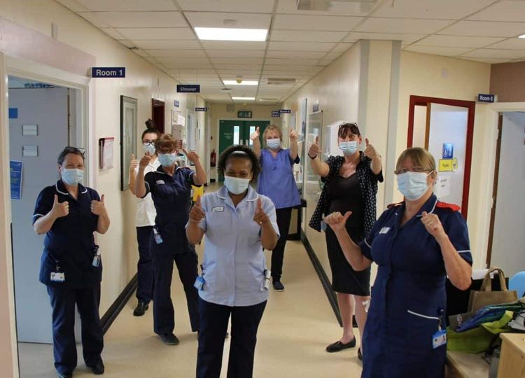 Millie Magadlela (middle) first day back at work on Aug 6 2020. Credit;SWNS