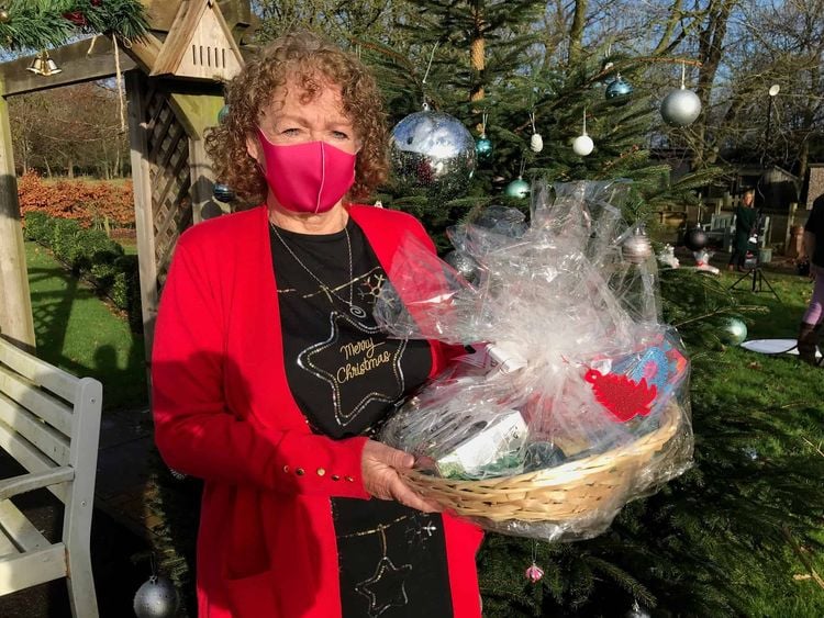 Carer Norma Kirby at Charnley Fold Day Centre in Bamber Bridge near Preston with a Christmas hamper delivered by Lottery winner Natalie Cunliffe. Credit;PA