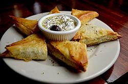 Filo pastry parcels with feta, couscous, and dates