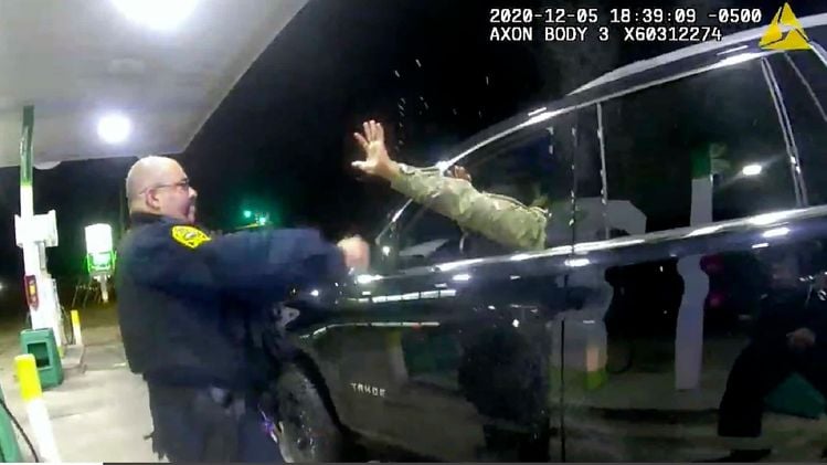 In this image made from Windsor, (Va.) Police video, A police officer uses a spray agent on Caron Nazario on Dec. 20, 2020, in Windsor, Va. Nazario, a second lieutenant in the U.S. Army, is suing two Virginia police officers over a traffic stop during which he says the officers drew their guns and pointed them at him as he was dressed in uniform. Caron Nazario says his constitutional rights were violated by the traffic stop in the town of Windsor in December. (Windsor Police via AP)