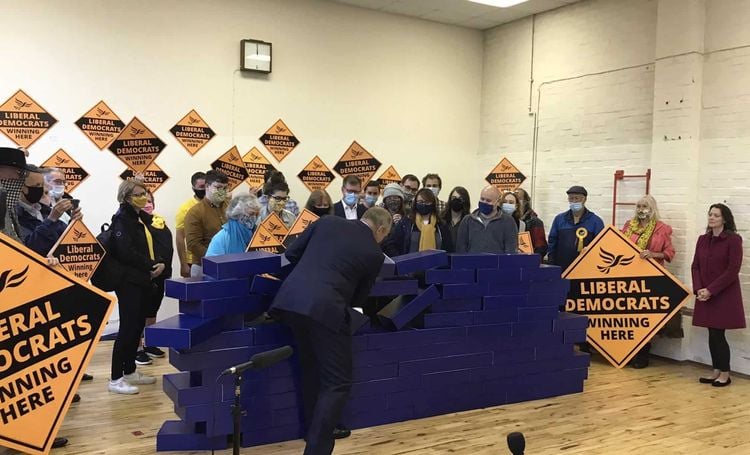 Ed Davey demolishing the blue wall after the Lib Dem victory in Chesham and Amersham