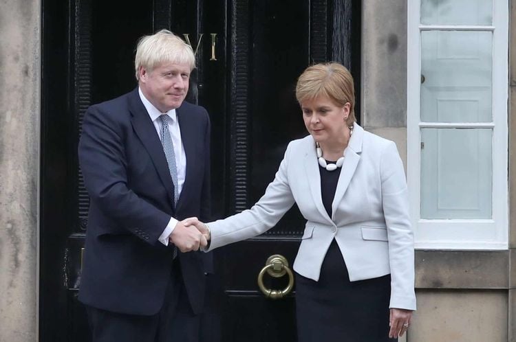 RETRANSMITTED CORRECTING BYLINE Scotland's First Minister Nicola Sturgeon welcomes Prime Minister Boris Johnson outside Bute House in Edinburgh ahead of their meeting.