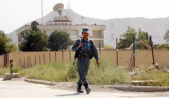 A guard walks in front of the British Embassy in Kabul, Afghanistan.