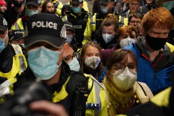 Climate activist Greta Thunberg is guidedn by police officers as she arrives at Glasgow Central train station ahead of the Cop26 summit which is taking place from Monday. Picture date: Saturday October 30, 2021.