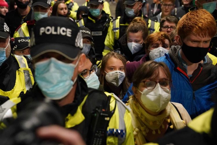 Climate activist Greta Thunberg is guidedn by police officers as she arrives at Glasgow Central train station ahead of the Cop26 summit which is taking place from Monday. Picture date: Saturday October 30, 2021.