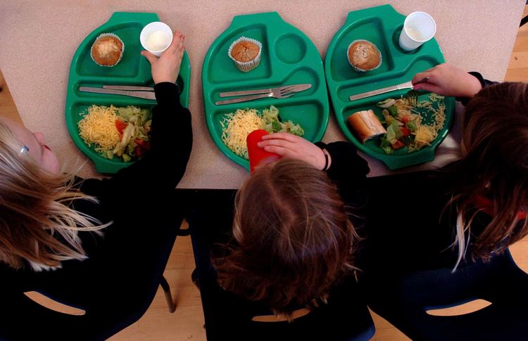 PARENTAL PERMISSION OBTAINED. Generic picture of pupils enjoying school dinners at a Primary School in Cambridgeshire.