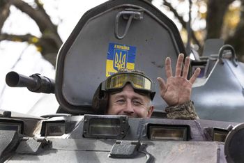 DONETSK DISTRICT, UKRAINE - OCTOBER 04: A soldier waves from an armored personnel carrier heading to the front lines on October 4, 2022 outside of Kramatorsk, Ukraine. Ukrainian Armed Forces pressed forward with gains in the east and south of the country, forcing Russia to retreat from several positions, with several villages liberated in the Kherson district. (Photo by Paula Bronstein/Getty Images)