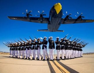 Marines of the Silent Drill Platoon, Marine Barracks Washington, execute their drill sequence during the Blue Angels’ “Fat Albert” C-130J Super Hercules fly-over at Marine Corps Air Station, Yuma, Ariz. Photo by LCpl Ramakrishna / US Marines