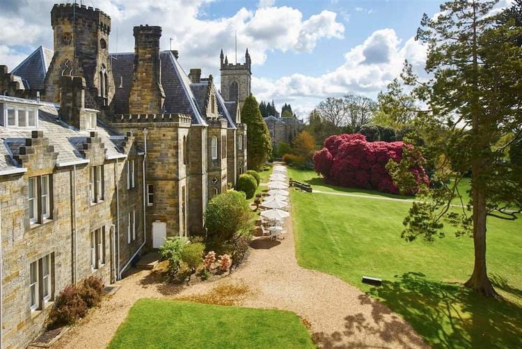 A view of the exterior of Ashdown Park Hotel, including its terrace and grounds