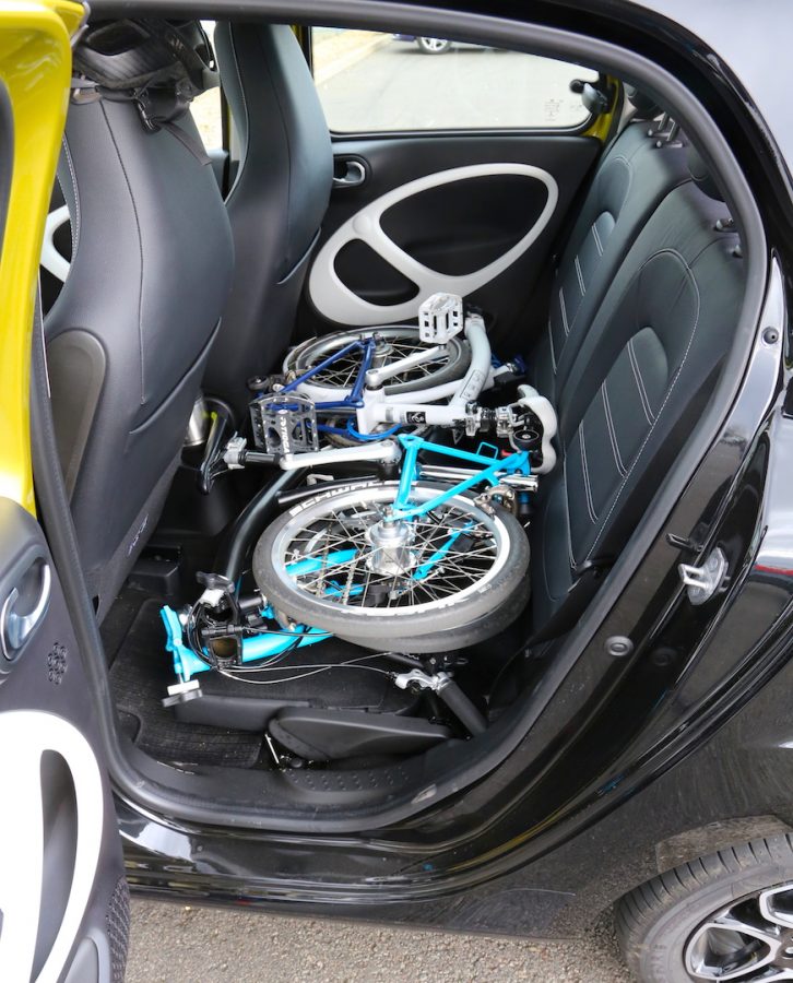 Two Brompton folding bikes fit with ease when the rear seat bases are flipped.