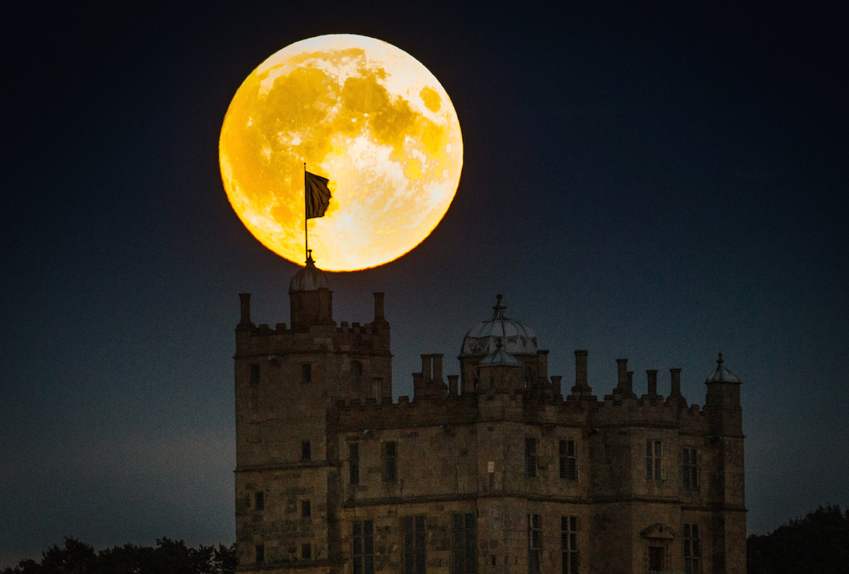 SWNS Pictures of the Year 2015 - One hundred of the most compelling images on the SWNS wire this year as chosen by our picture editors. A supermoon rises above Bolsover Castle, Derbyshire tonight, 27 September 2015. Astronomers will be given a rare chance to capture a spectacular celestial event, a blood red supermoon, that has not occurred for 30 years tonight 27 September 2015.