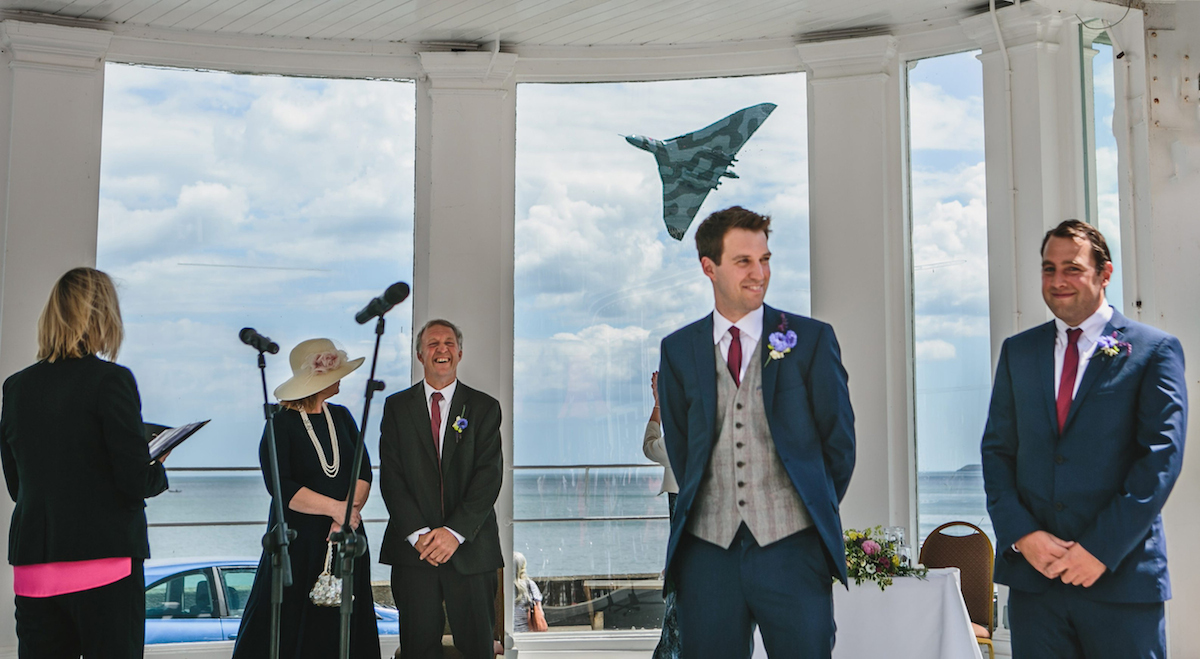 SWNS Pictures of the Year 2015 - One hundred of the most compelling images on the SWNS wire this year as chosen by our picture editors. PLEASE USE PHOTOGRAPHER CEDIT. Mark Tierney / SWNS Pictured - Jonny Smith on his wedding day, getting photo bombed by the Vulcan. See Ross Parry copy RPYBOMBER. These amazing pictures show the startling moment a Vulcan Bomber PHOTOBOMBED a wedding. The Cold-War icon upstaged the bride for just a moment as the distinctive aeroplane - one of the greatest achievements of British aerospace engineering - flew past iconic Scarborough Spa during one of the final tours of the skies of Britain before it is grounded forever. The Vulcan XH558 was on a Salute the V Force Tour on Saturday when it flew over Jonny and Emily Smith's ceremony at 1.23pm.