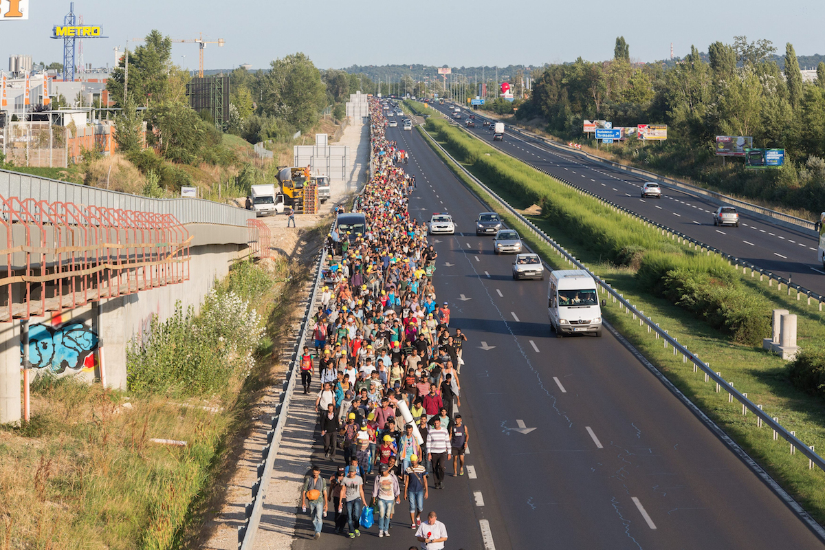 SWNS Pictures of the Year 2015 - One hundred of the most compelling images on the SWNS wire this year as chosen by our picture editors. Thousands of migrants in Hungary march along the M1 in the direction of Austrian border. Many had been refused access to trains in Budapest so have started marching to the border on foot. September 04 2015.