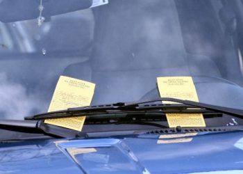 Two parking tickets, tucked beneath a single windshield wiper, await a likely angry driver when he returns to his vehicle on a street in downtown Doylestown PA. 2008-04-05.