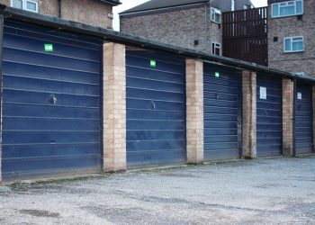 The garage doors in Midsummer Avenue, Hounslow. See SWNS story SWGARAGES3; Councils in London could build more than 16,000 homes by using space taken up by the unused or rundown garages it owns, according to new research. A study of local authority-owned lock-ups revealed 24 councils own 53,640 garages in the capital - with 41 per cent empty or in disrepair. Demolishing the garages and replacing them with affordable one-bedroom flats could go someway to solving the London housing crisis, where the average home now costs £475,000.  The figures were revealed in a Freedom of Information request by property crowdfunding platform Property Partner. Researchers at property firm calculated the total square footage of 22,000 council-owned empty garages in London was more than eight million. If these garages were replaced with developments made up of 500 sq/ft flats, it is estimated 16,000 affordable homes could be built. The London Assembly says the capital needs between 49,000 and 80,000 homes per year to cope with the projected population growth of a million in the next ten years.