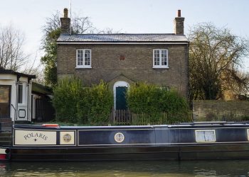 Ferry House situated on the bank of the river cam in Cambridge next to the Fort st George pub and close to the Mihelin star restaurant Midsummer house. See SWNS copy SWCOUNCIL:A riverside home with a Michelin-starred restaurant on its doorstep is set to become one of the UK’s most expensive COUNCIL HOUSES after it was put on the market for £750,000.Ferry House is a three-bedroom 'doer upper', which sits on the bank of the River Cam in Cambridge. It is in heart of the historic city centre and within half-a-mile of a mixture of ancient and modern buildings, colleges and shops.