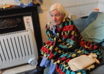 Pictured is Shirley Walsh at her home on Kathleen Road, Hull, where she is forced to use electric heaters, hot water bottles and blankets to keep warm. See Ross Parry story RPYCOLD; A 74-year-old widow has been left "freezing" in her Hull home for months after her gas was cut off leaving her with no central heating or hot water. Shirley Walsh, from east Hull, takes SIX hot water bottles to bed with her at night in a desperate bid to keep warm. The retired seamstress says her supply was cut off in September after workmen found a leak in pipes under her front garden in Kathleen Street, where she has lived for 43 years. But because the leak was on her property, Northern Gas Networks told her she would have to pay for the repair, a cost the pensioner says she can't afford.