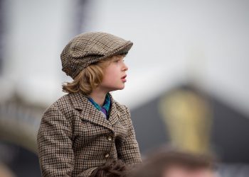 A young boy watches the third race of the day at the Gold Cup, the final day of the horse racing, at the Cheltenham Festival 2017, which is also St Patrick's Day. March 17 2017.