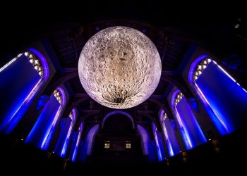 Artist Luke Jerram with his installation, Museum of the Moon, in the University of Bristol Great Hall, Wills Memorial Building, Bristol. See SWNS story SWMOON; Measuring seven metres in diameter, Luke’s Moon features detailed NASA imagery of the lunar surface. Each centimetre on his moon represents 5km on the surface of the Earth's largest natural satellite. The installation in the Great Hall is part of the Moon’s international tour in which it is presented in different ways, both indoors and outdoors, altering the experience of the artwork for different audiences worldwide.