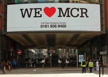 We Love Manchester signs have begun to pop up around the city to show solidarity and to share a helpline for those effected by last nights terror attack in the city. At least 22 people have died, with more than 60 injured after an 'explosion' tore through a pop concert at Manchester Arena in a suspected terror attack. In a statement, GMP said: "This is currently being treated as a terrorist incident until police know otherwise." Officers were called to reports of an explosion at the Manchester Arena just before 10.35pm on Monday, May 22. "So far 19 people have been confirmed dead, with around 50 others injured," the force said. Multiple witnesses reported hearing two "huge bangs" at the venue shortly after US singer's gig finished at around 10.30pm on Monday evening. The area around the arena was swamped with police and emergency services and approach roads were cordoned off.