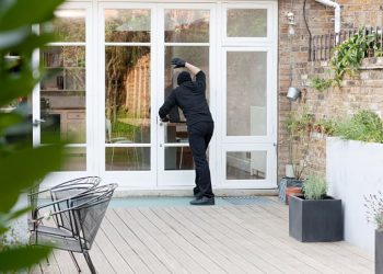 Burglar standing at patio door